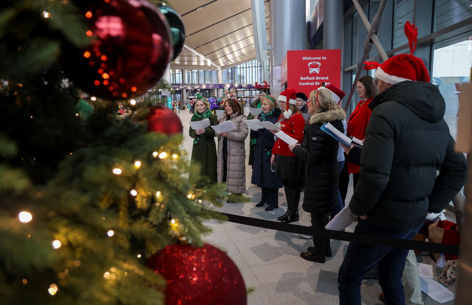A photo of the Translink staff choir performing in Belfast Grand Central Station