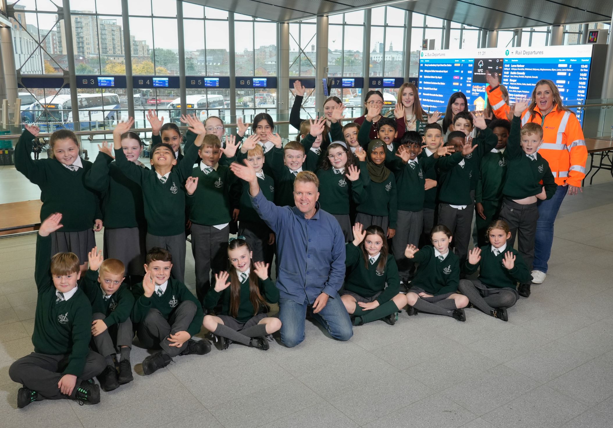 A photo of Ed Reynolds with a group of children in school uniforms