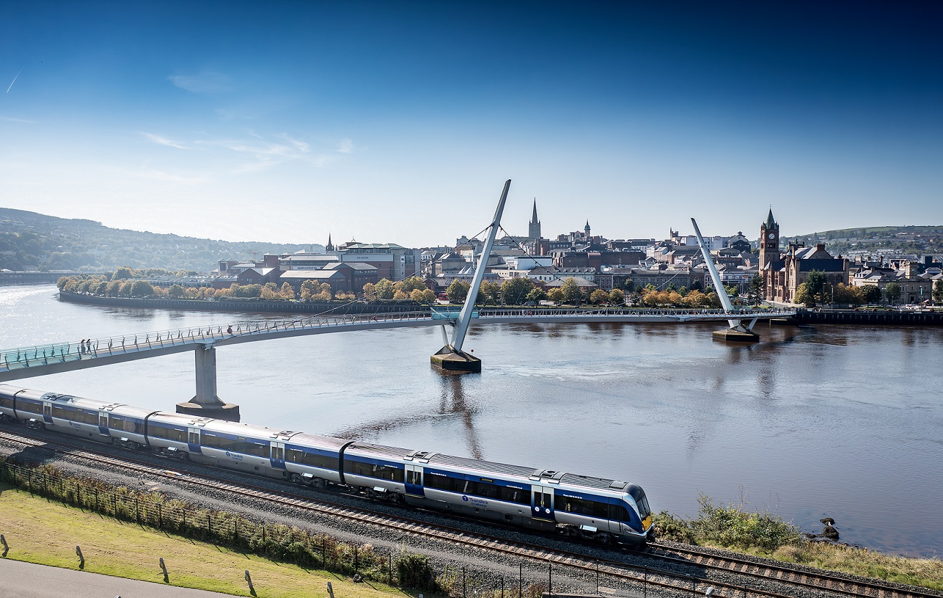 A Train passing the Millennium Bridge in Derry~Londonderry