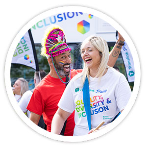 Translink Reps Cara Woods and Gordon Milligan with Translink’s special rainbow coloured Pride Bus